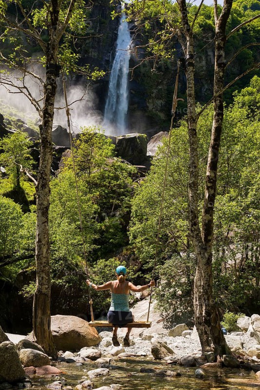 Woman on swing and waterfall, Foroglio, Bavona Valley, Valle Bavona, Maggia Valley, Valle Maggia, Canton of Tessin, Switzerland