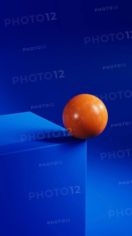 An orange sphere balances elegantly on a vibrant blue geometric shape, creating a striking contrast in this minimalist abstract composition