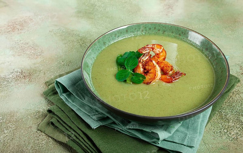 Pea cream soup, with shrimp, green soup, homemade, top view, no people