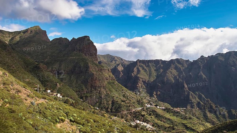 Green mountains and rocks under a cloudy blue sky, Masca, Barranco de Masca, canyon, Teno, Teno Mountains, northwestern Tenerife, Tenerife, Canary Islands, Spain