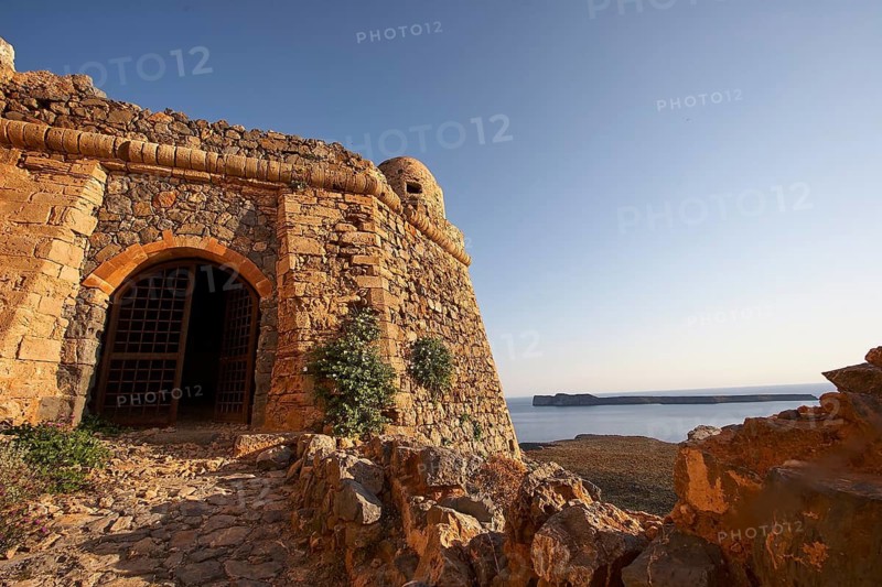 Super wide angle, fortress walls, fortress gate, defence defence tower, paved path, elongated island of Agria Gramvoussa, Venetian sea fortress of Gramvoussa, peninsula of Gramvoussa, Pirate Bay, Balos, Tigani, blue cloudless sky, Western Crete, island of Crete, Greece