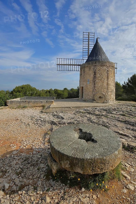 Moulin de Daudet historic windmill built in 4th century and millstone, Fontvieille, Alpilles, Alpilles, Bouches-du-Rhône, Provence, France