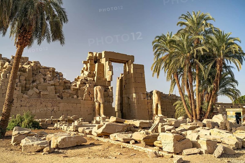 Palm trees and ruins at Karnak Temple in Karnak near Luxor, Egypt