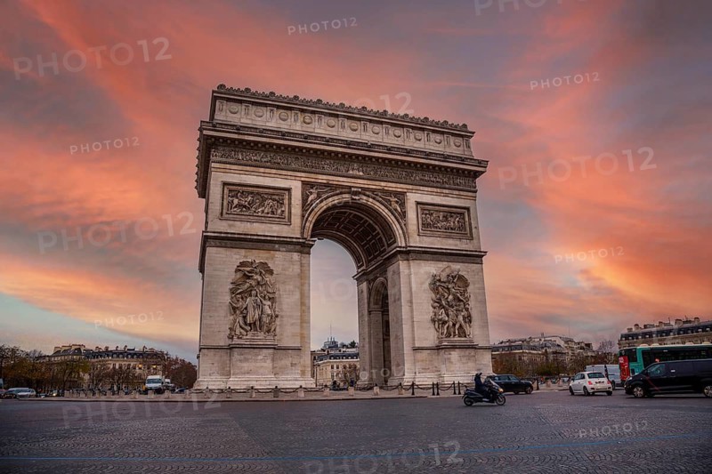 Orange sunset at the Arc de Triomphe in the beautiful European city of Paris. France