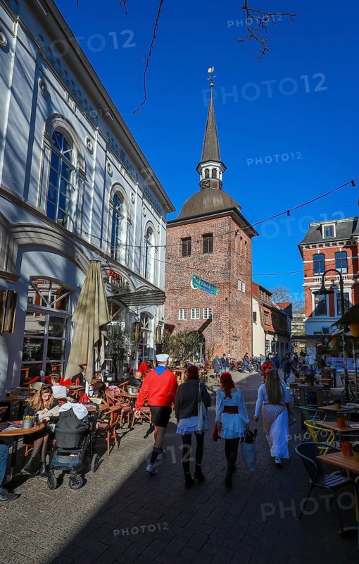 Oldenburg, Lower Saxony, Germany - Historic city centre, here the Wallstraße, Oldenburg's pub mile in the pedestrian zone, at the back of the Lange Straße the Lappan, an old bell tower with a Renaissance dome, a sight in the old town of Oldenburg. The pedestrian zone is characterised by historic buildings, small alleyways, a variety of owner-managed shops and gastronomic offerings