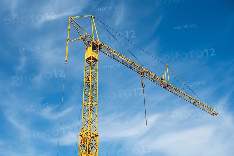 Construction crane against blue sky with white clouds, Soest, Westphalia, North Rhine-Westphalia, Germany