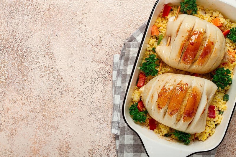 Stuffed squid carcasses, baked in the oven, fried, with couscous, top view, homemade, no people