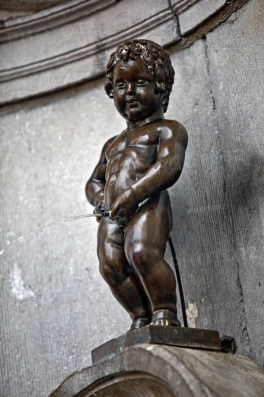 Bronze statue Manneken Pis by Jérôme Duquesnoy, fountain figure of a urinating boy, a landmark of Brussels, Belgium
