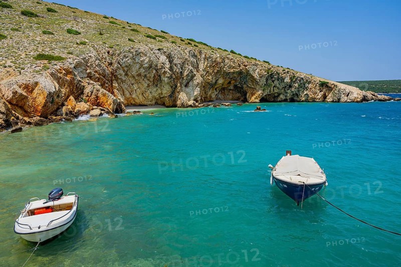 Boats lying on the sea in Koromacna Bay on a sunny day on the island of Cres, Croatia