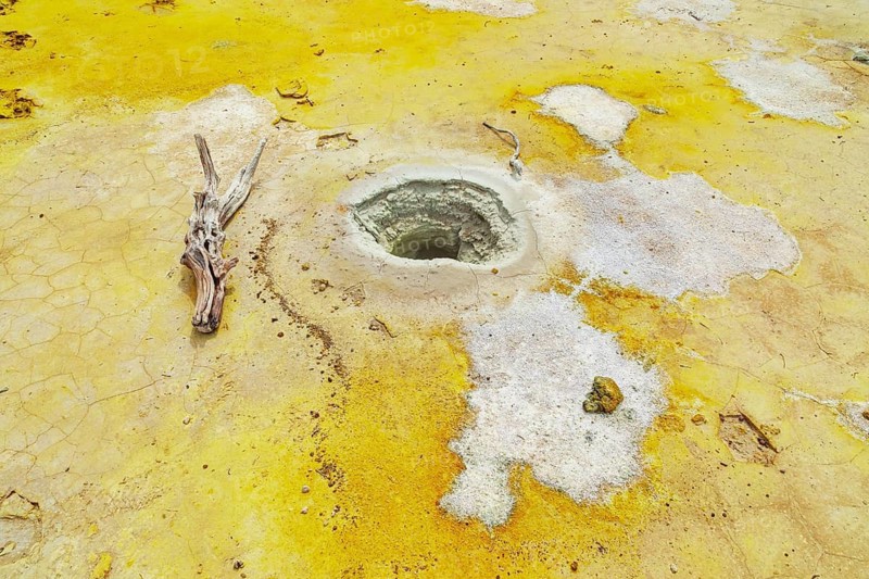 Splashes of sulphur colouring Stefanos crater ground, Nisyros Island, Dodecanese Islands, Greece