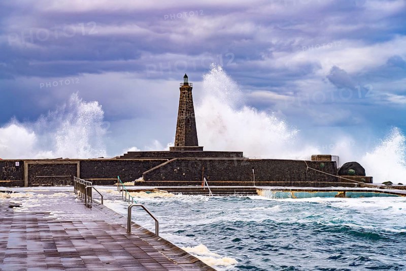 Surf at the seawater swimming pool and the Faro de Bajamar lighthouse, Bajamar, San Cristóbal de La Laguna, Tenerife, Canary Islands, Spain