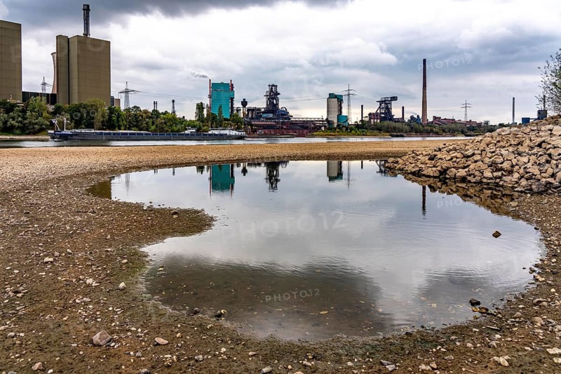 Extreme low water in the Rhine, the du-Ruhrort level was 130 cm at the time of recording, the lowest water level so far in 2018 was 153 cm, Hüttenwerke Krupp-Mannesmann, HKM, gas power plant, cargo ships on the Rhine only travel with a significantly reduced load, view of Du-Friemersheim to Duisburg-Wanheim, North Rhine-Westphalia, Germany
