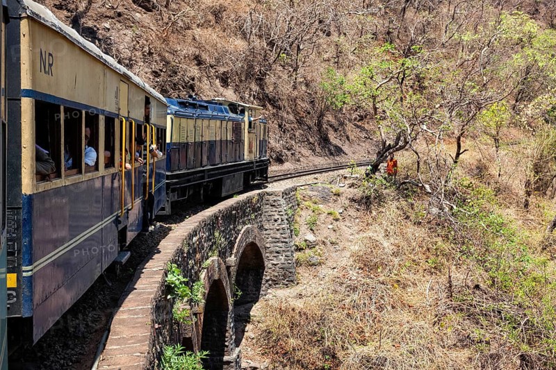 HIMACHAL PRADESH, INDIA, MAY 12, 2010: Toy train of Kalka–Shimla Railway, narrow gauge railway built in 1898 and famous for its scenery and improbable construction. It is UNESCO World Heritage Site