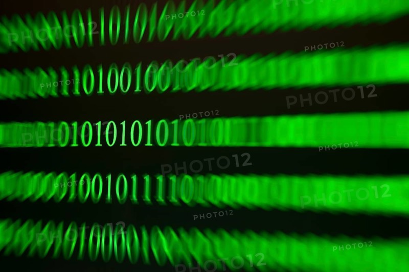 A blurred green binary code as a sign of movement and speed