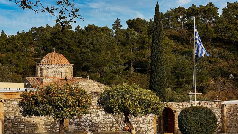 Stone church with Greek flag and cypress in the foreground, Thari Monastery, Moni Thari, near Gadouras Reservoir, lonely mountain region, Rhodes, Dodecanese, Greek Islands, Greece