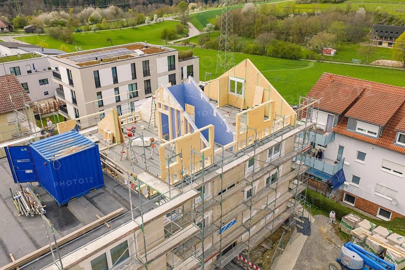 Construction site with a partially constructed building, wooden scaffolding and a construction container, residential renovation, Nagold, Calw district, Germany