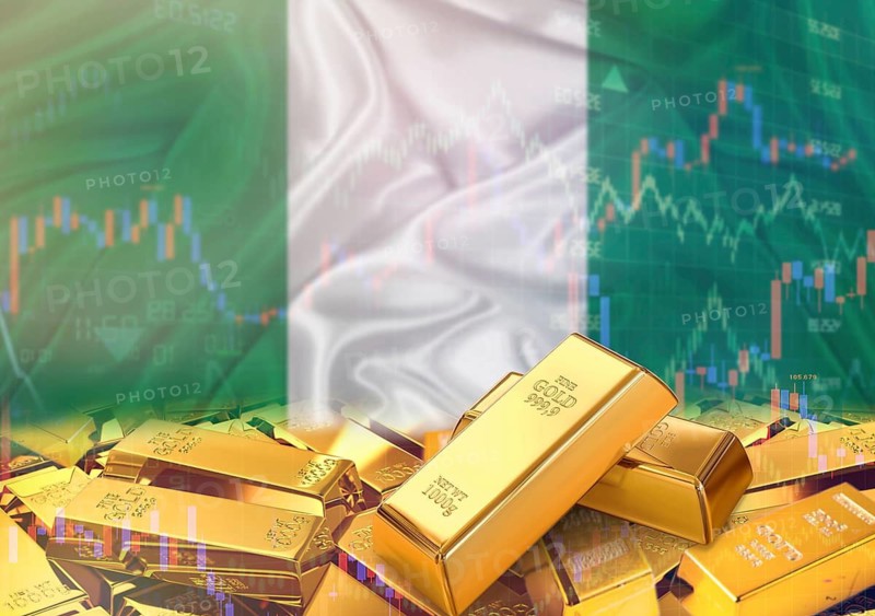 Gold bars on Nigerian flag in background. Gold bars stacked on Nigerian flag. Concept of Nigeria gold reserves