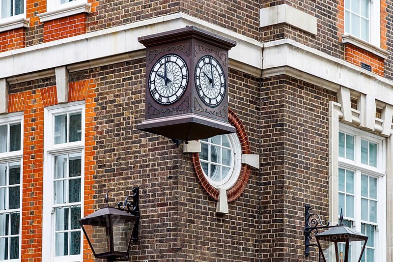 A projecting double faced clock decorates the red brick corner of the Great Scotland Yard Hotel, recalling the sites long association with British policing. The original Great Scotland Yard premises became linked with the Metropolitan Police in the 19th century, London, England, United Kingdom