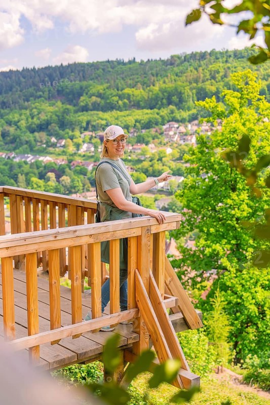 Woman on the platform presents the view over the valley and the surrounding hills, Panorama Holzsteg, Calw, Black Forest, Germany