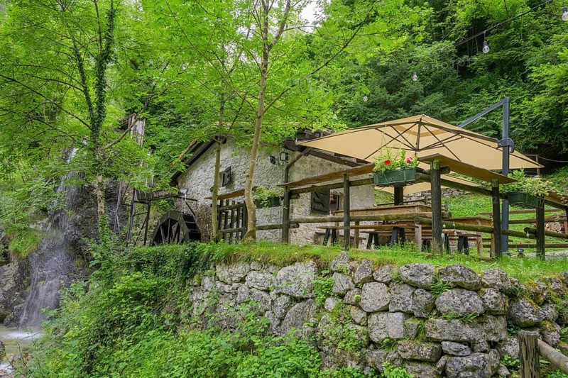 Mill wheel and waterfall at the old mill, Tramonti di Sopra, Province of Pordenone, Italy