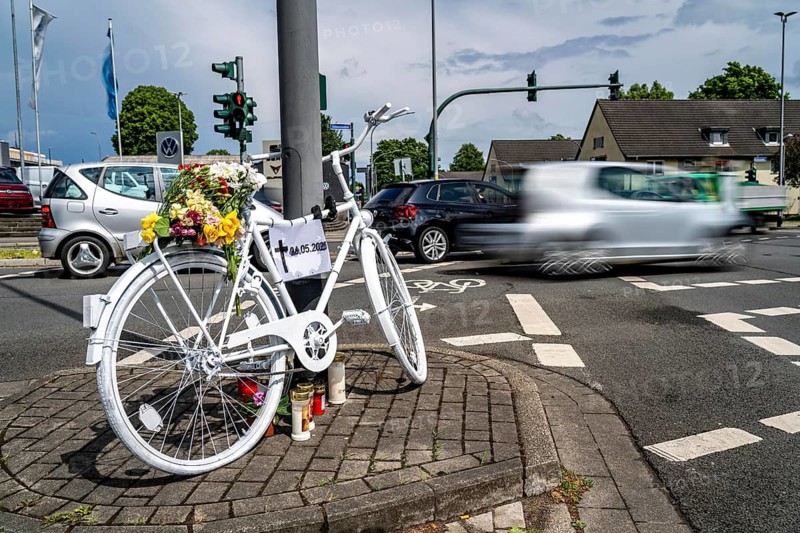 A ghost bike at the scene of an accident where a cyclist was run over by a lorry two days earlier and died, the white-painted bike is intended to serve as a memorial at the junction to commemorate the accident and remind people to drive more carefully, Essen-Kray, North Rhine-Westphalia, Germany