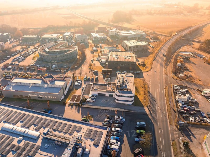 Bird's eye view of industrial plants and roads in sunny weather with surrounding landscape, Gültstein, Herrenberg, Germany