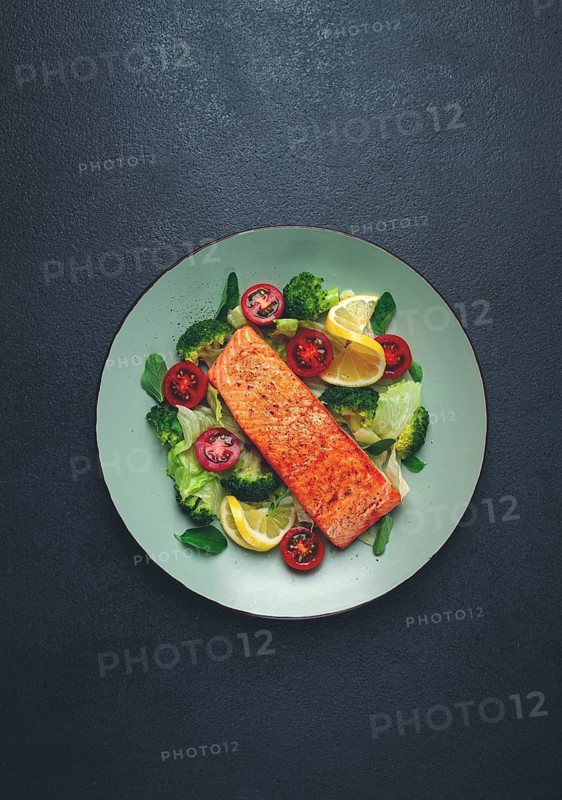 Grilled salmon fillet, with vegetables, broccoli, cherry, iceberg lettuce, spices and herbs, homemade, no people