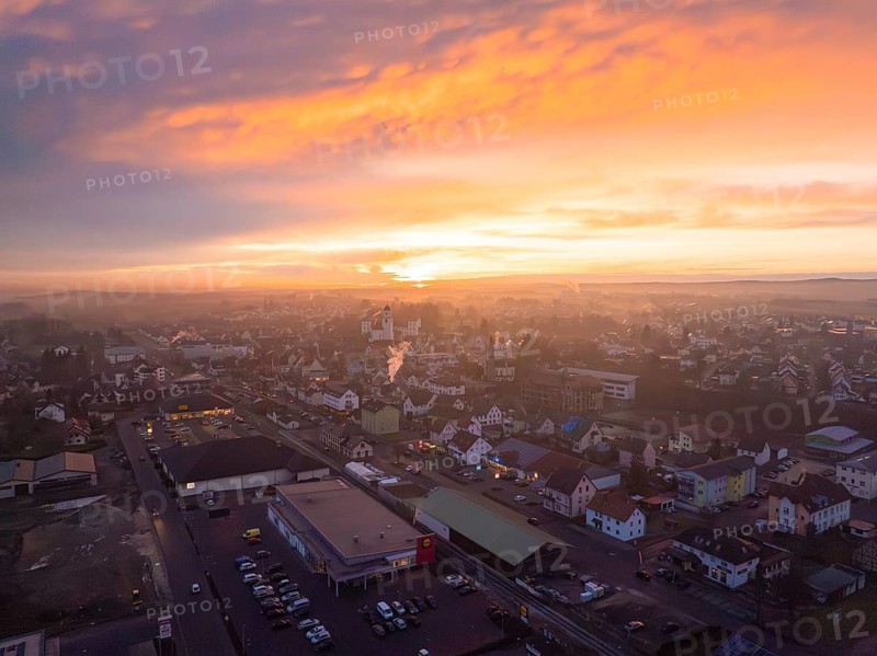 Landscape at sunset, the town in warm, bright colours and clouds, Meßkirch, district of Sigmaringen, Germany