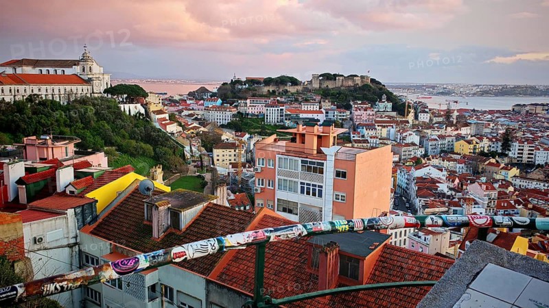 Extensive view of Lisbon's rooftops at dusk with wide skies, Miradouro da Senhora do Monte McMlxii viewpoint, Lisbon, Portugal