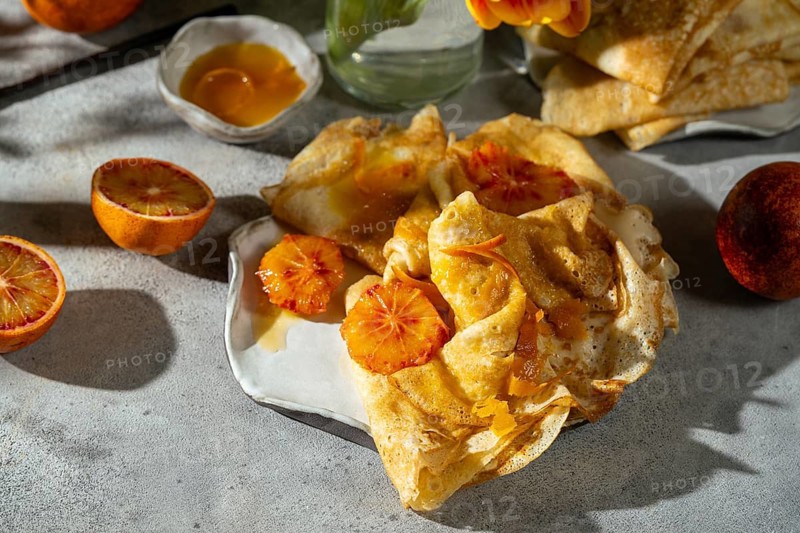 Golden crepes topped with a luscious sauce of caramelized sugar, butter, and blood orange juice, garnished with fresh blood orange slices