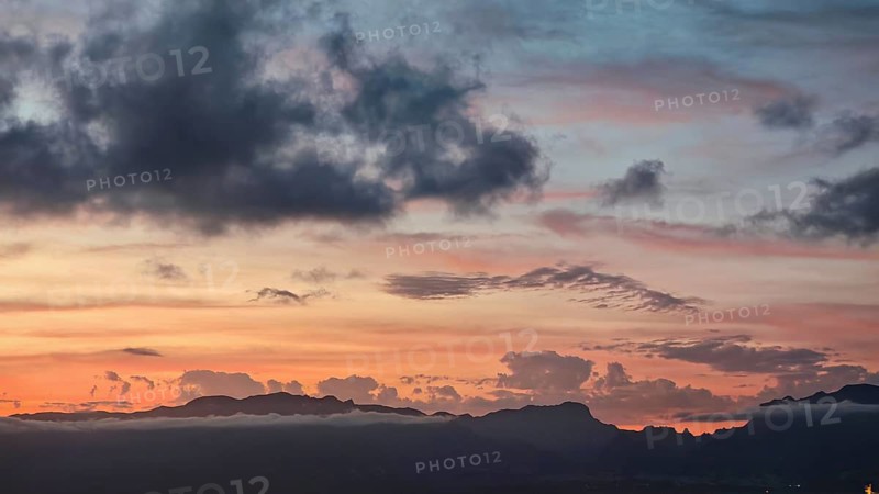 A sunset with orange sky and mountains in the background, Santo Antao mountains in the background, Mindelo, Sao Vicente, Cabo Verde, Cape Verde, Cape Verde