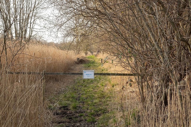 No entry sign across a path, RSPB Fowlmere nature reserve, Cambridgeshire, England, United Kingdom