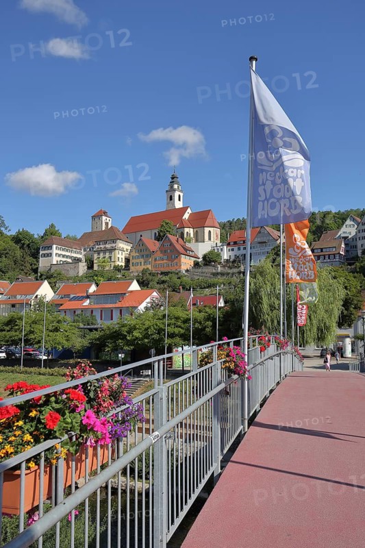 Flags on Raftssteg and cityscape with Schütteturm observation tower, collegiate church and rogue tower, Horb am Neckar, Neckar Valley, Northern Black Forest, Black Forest, Baden-Württemberg, Germany