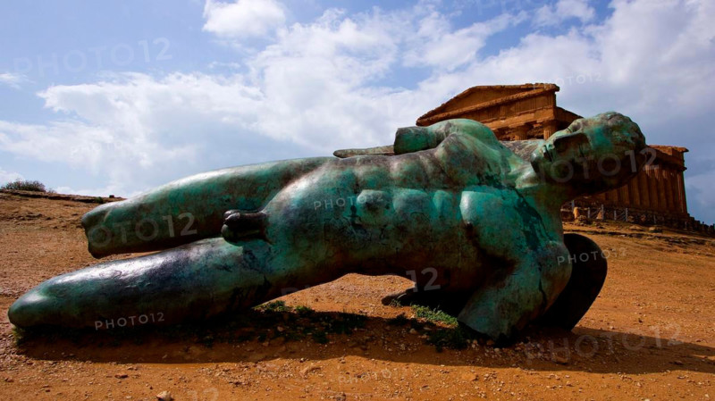 Super wide angle shot, bronze statue of fallen Icarus, Concordia Temple, Valley of the Temples, valle dei templi, Agrigento, Sicily, Italy