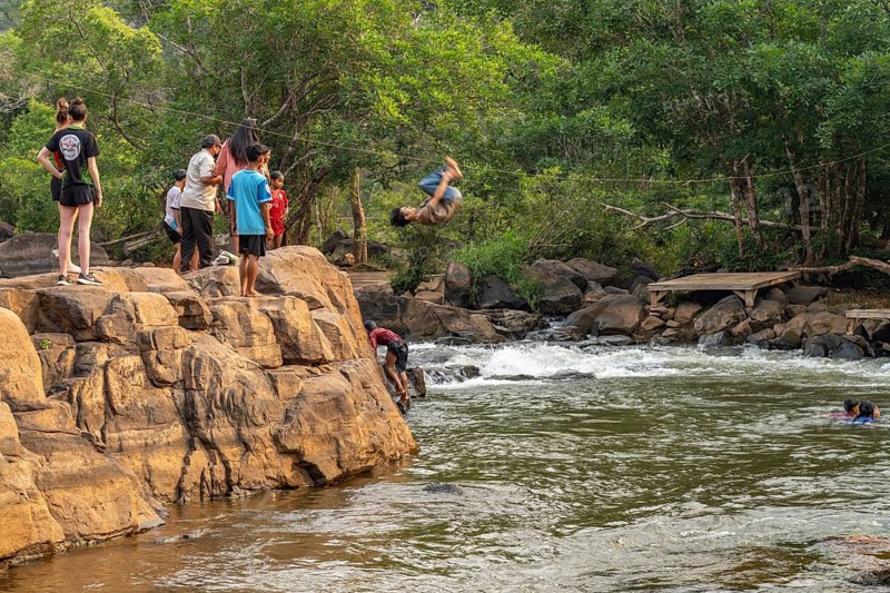 Children jumping into the river Tad Lo, Bolaven Plateau, Laos
