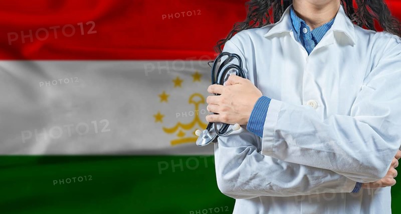 Healthcare professional with Tajikistan flag background. Professional doctor holding stethoscope on Tajikistan flag background