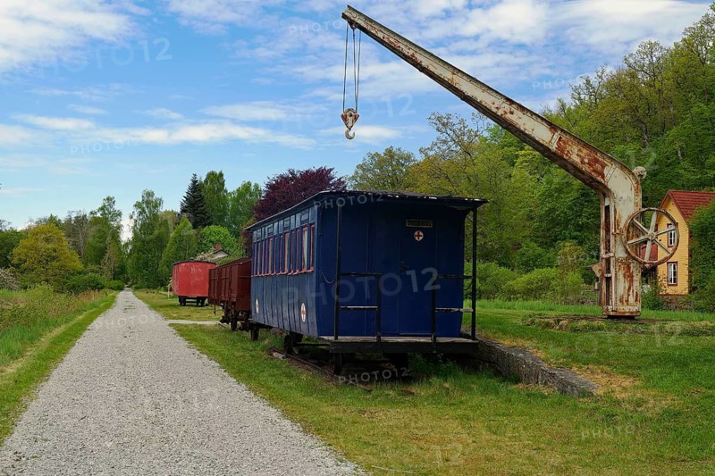 Abandoned train wagon on a rail with an old crane in rural area, cycle route, Banevallsleden, Smaland, Sweden, cycle route, Banevallsleden, Smaland, Sweden