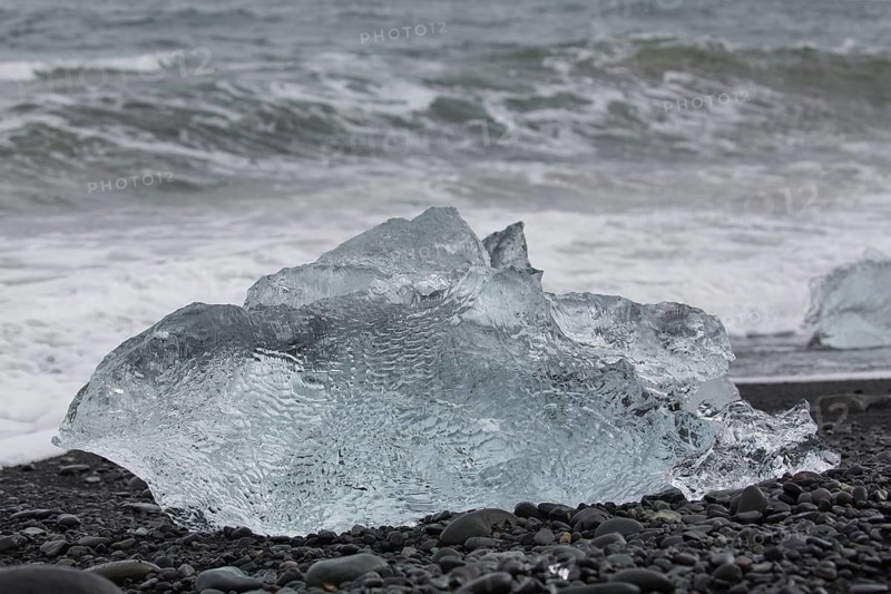 Little icebergs and crushed ice on the black beach at Joekulsarlon glacial lake