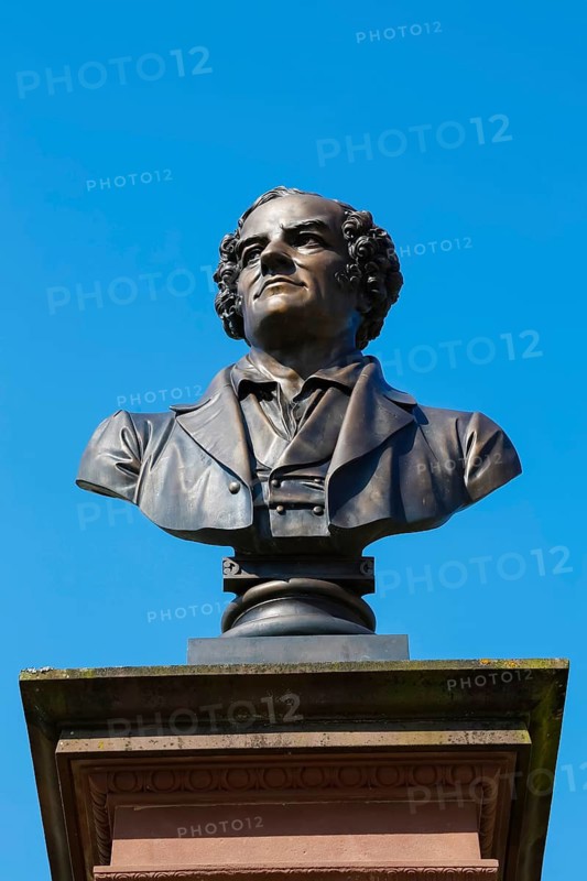 Monument in honour of Conradin Kreutzer, musician, conductor and composer, bust by Hans Baur, sculptor, sculpture, portrait, portrait, head, face, detail, pedestal, writing, letters, art in public space, statue, blue sky, cloudless, Meßkirch, district of Sigmaringen, Baden-Württemberg. Germany