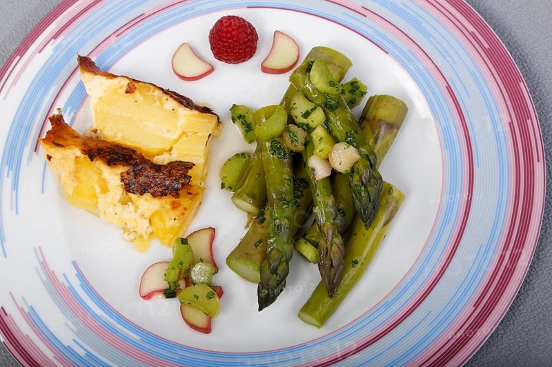 South German cuisine, green asparagus with rhubarb vinaigrette and potato gratin, healthy, vegetables, plated, vegetarian, traditional cuisine reinterpreted, food photography, studio, Germany