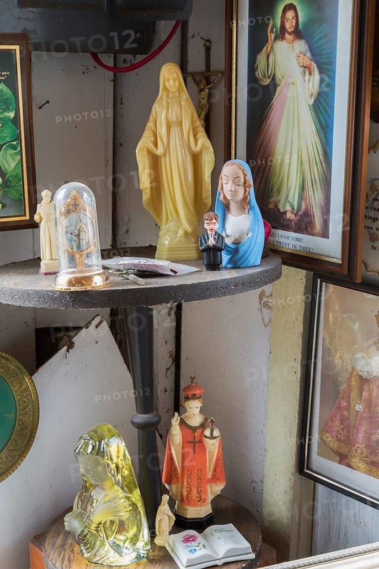 Religious statues and painting for sale inside second hand goods and chattels store, Quebec, Canada
