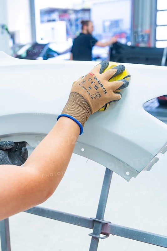 Person grinds a car part in a workshop with precision and craftsmanship, painter, Calw, Germany