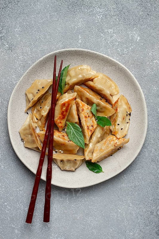 Japanese fried gyoza dumplings, with pork, sesame seeds, green onions