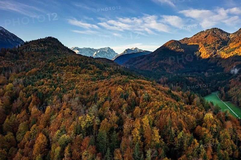 Aerial view of autumnal forest in front of mountains in the morning light, view of Zugspitze, Alpine foothills, Upper Bavaria, Bavaria, Germany