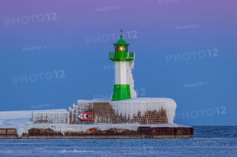 Ice covered Molenfeuer, frozen lighthouse, pier light on mole in the harbour of Sassnitz in winter, Rügen Island, Mecklenburg-Vorpommern, Germany