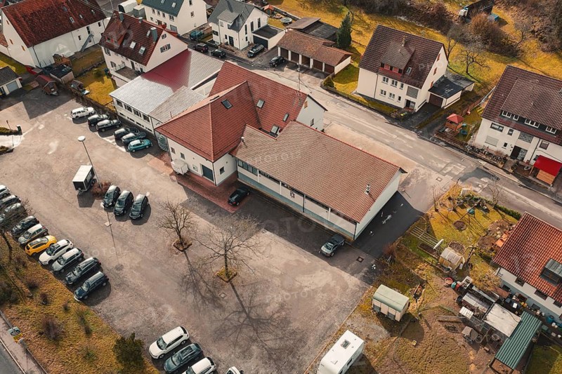 Aerial view of a village with buildings and parked cars in a quiet winter landscape, fire station, Gechingen, Calw district, Germany
