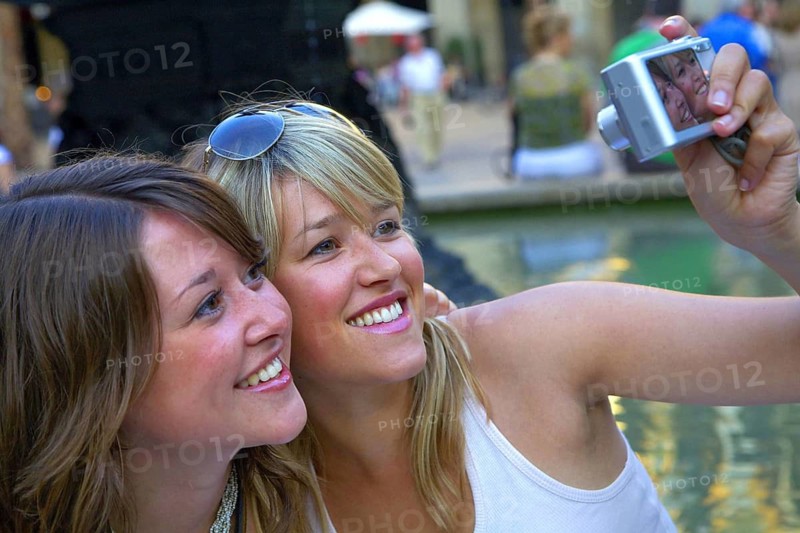 Two woman taking a selfie with the camera, Barcelona, Spain