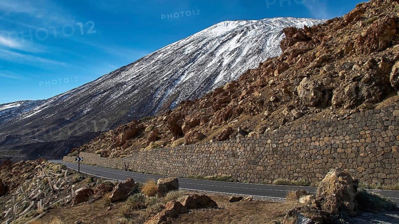 A winding road passes a snowy mountainside, Teide, Parque Nacional del Teide, Teide National Park, volcano, volcanism, UNESCO World Heritage Site, Tenerife, Canary Islands, Spain