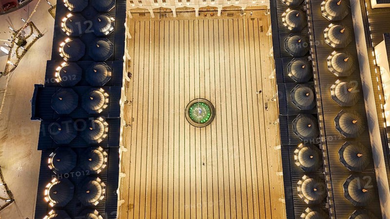 Aerial view captures hundreds of Muslims gathered at long tables for a communal Iftar meal in a festively decorated square outside a large mosque in Gaziantep, Turkey on March 11, 2026, Gaziantep, Turkey