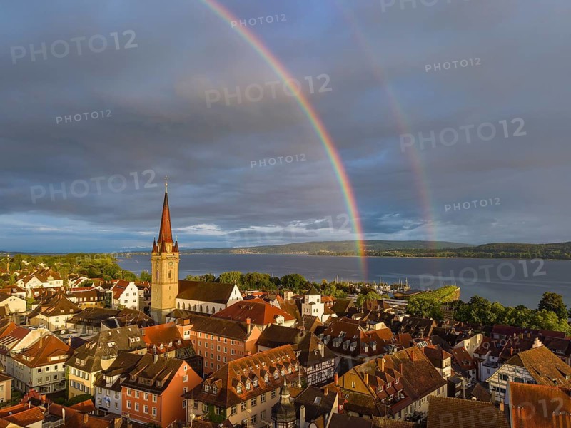 Aerial view of the historic old town of Radolfzell am Lake Constance with the cathedral illuminated by the evening sun, behind it a rainbow, district of Konstanz, Baden-Württemberg, Germany